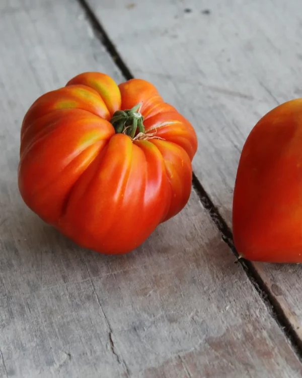 Tomates cœur de bœuf rouges sur une table en bois